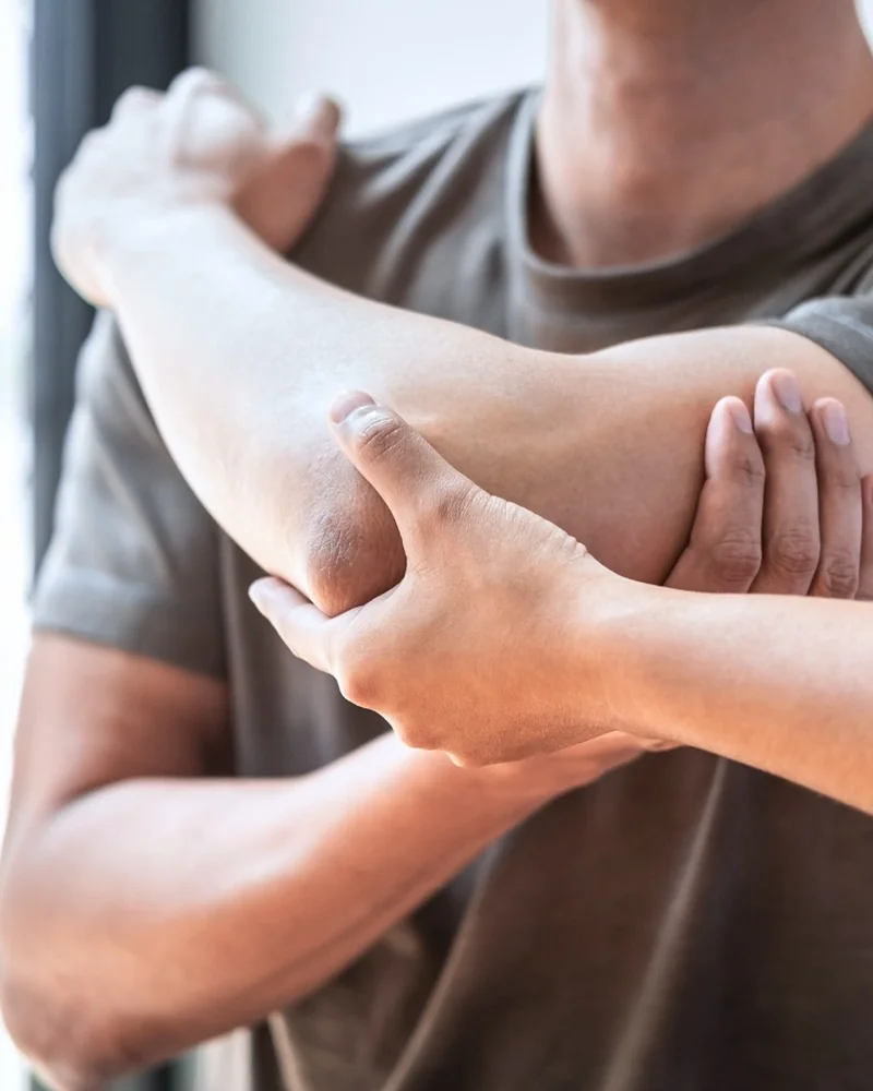 Therapist assessing a patient's elbow and forearm